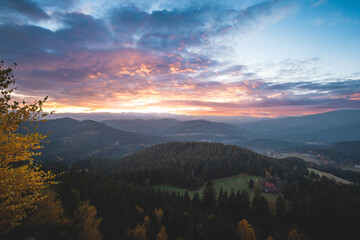 Beskydy mountains at colorful sunset. Autumn forest, rolling hills and peaceful valley evoke...