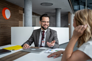 Businessman explaining business strategy to female partner during meeting