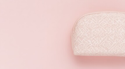 An elegant pink cosmetic bag placed on a soft gradient background, embodying simplicity and style.

