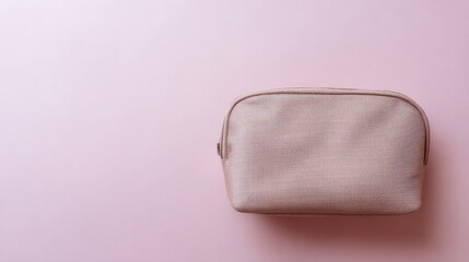 An elegant pink cosmetic bag placed on a soft gradient background, embodying simplicity and style.
