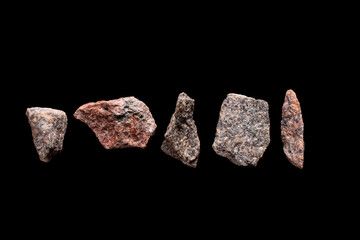 Granite pieces isolated on black background.