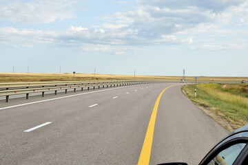 Fototapeta premium Cars drive along a modern expressway