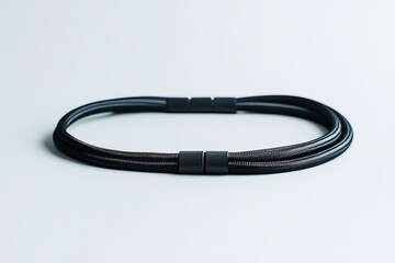 Black magnetic necklace on white background for style and wellness, modern jewelry design