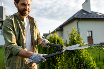 Man in the garden working with the prune and looking involved