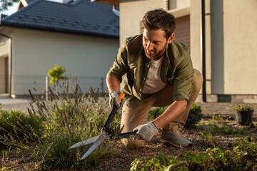 Man working in the garden and looking involved and busy