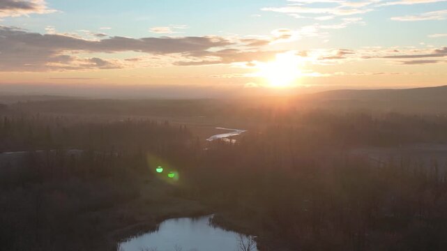 xa drone aerial view over sunrise on a foggy morning is highly atmospheric and cinematic, perfect for stock platforms, Drone Aerial View of Sunrise Over Foggy Landscape &ndash; Peaceful Morning Atmosphere