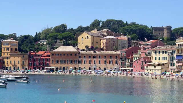 View from rock on sea, Bay of Silence, fishing cove of the town of Sestri-Levante, Italy. Tourism and recreation. Ecologically clean nature. Traditional old buildings. Historical center.