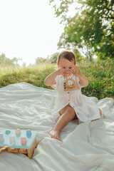Happy little baby girl playing in a sunny park. Childhood joy, Mother's Day, outdoor activity,...