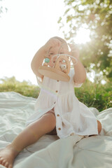 Happy little baby girl playing in a sunny park. Childhood joy, Mother's Day, outdoor activity,...