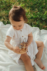 Happy little baby girl playing in a sunny park. Childhood joy, Mother's Day, outdoor activity,...