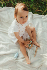 Happy little baby girl playing in a sunny park. Childhood joy, Mother's Day, outdoor activity,...