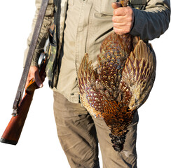 Side view of hunter carrying dead pheasant while walking on field