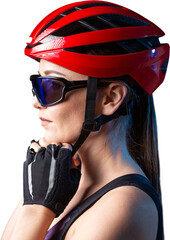 A young female cyclist wearing a safety helmet and glasses, dressed in a bib shorts poses against a...