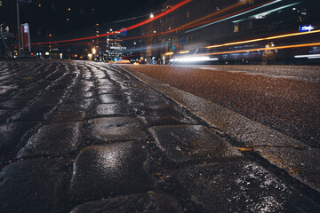 Close-up of paving stones in city at night