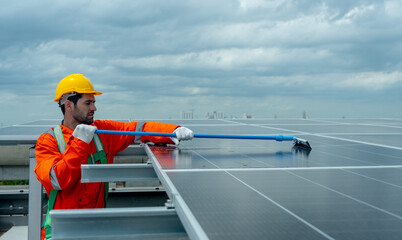 Wide shot of profession engineer or technician worker use cleaning brush to clean solarcell panel...