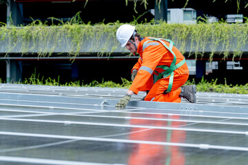 Professional technician worker or engineer sit on solar cell panel and check or maintenance in area...