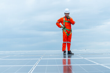 Technician worker or professional engineer stand on solarcell panel and use walkie-talkie during...