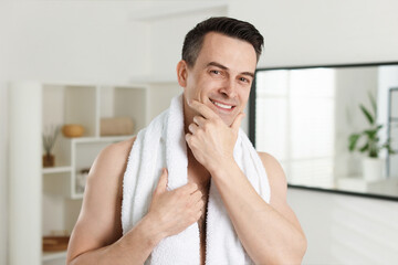 Portrait of smiling man after shaving at home