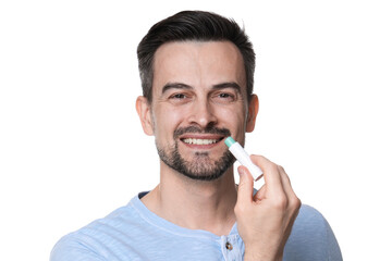 Smiling man applying lip balm onto his lips on white background