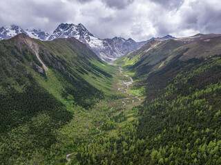 Fototapeta premium Beautiful aerial view of U-shaped valley landscape in Baima Snow Mountain