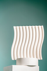 A sculptural wavy white backdrop stands on a minimalist white podium with a soft teal gradient background. Ideal for showcasing premium skincare, wellness products, or branding design presentations
