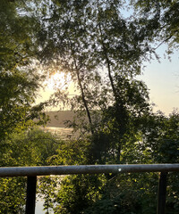A magical sunset over a quiet lake on a warm summer day. The golden-pink reflections of the sun's...
