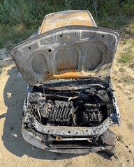 Vertical photo of a burnt car