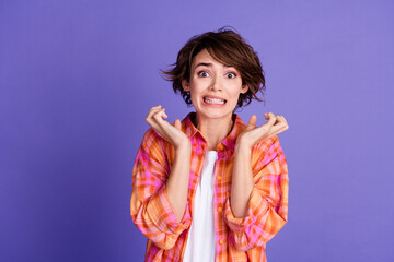 Portrait of nice young lady grinning raise hands empty space wear shirt isolated on purple color...