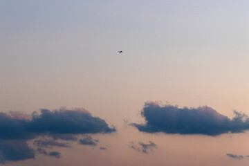 flying airplane in the sky after sunset