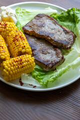 High Angle View of Grilled Meal of Steak, beef,corn and Vegetables Spread Out on Rustic Wooden Table