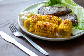 High Angle View of Grilled Meal of Steak, beef,corn and Vegetables Spread Out on Rustic Wooden Table