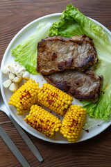High Angle View of Grilled Meal of Steak, beef,corn and Vegetables Spread Out on Rustic Wooden Table