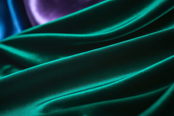 Emerald green silk fabric with purple and blue accents