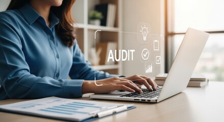 A woman working on a laptop with an audit concept on the screen