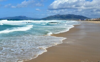 Beach with waves in Tarifa Spain where Atlantic and Mediterranean meet