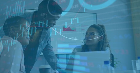 Colleagues analyzing financial charts around laptop and monitor in meeting room, with data overlays