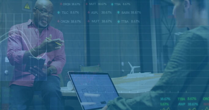 Gesturing senior man holding notepad in conference room, with laptop and turbine model, copy space - Powered by Adobe