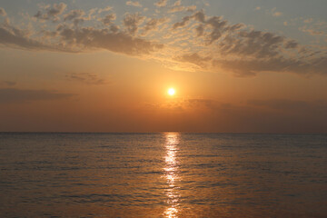 Sunset on the sea, clouds and a orange sea on a summer evening