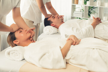 Caucasian couple enjoying relaxing anti-stress head massage and pampering facial beauty skin...
