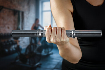 Close up of fit woman while intense strength workout in cinematic gym with sunlight and smoke –...