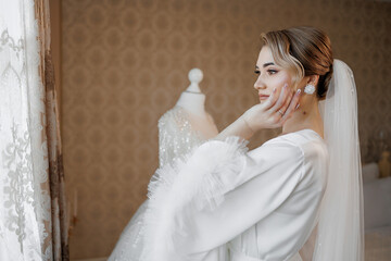 Bride preparing for wedding with elegant dress in soft natural light