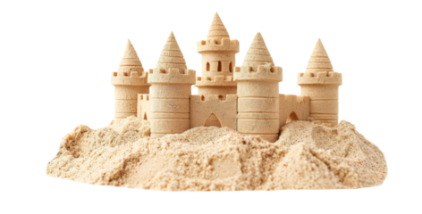 Sandcastle built with intricate towers and surrounding seashells demonstrates creativity at the beach during sunny summer day
