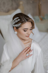 Bride preparing for wedding in elegant setting with stunning hairstyle and accessories