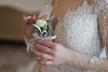 Elegant bride preparing for the ceremony with a delicate flower bouquet in hand