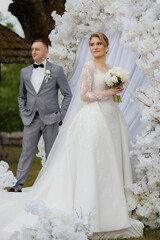 Elegant wedding ceremony taking place in a beautiful floral setting