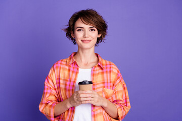Portrait of nice young lady hold coffee cup wear shirt isolated on purple color background