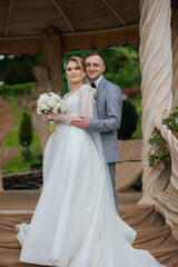 Elegant outdoor wedding ceremony featuring a smiling couple in formal attire