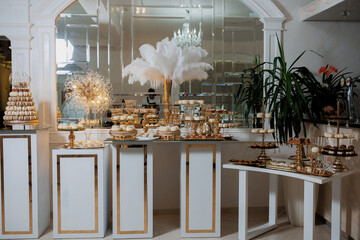 Elegant dessert display at a luxurious event venue showcasing pastries and decorative elements