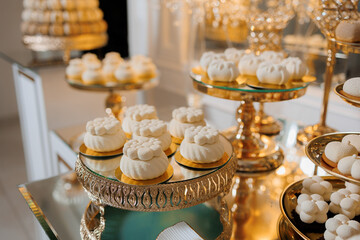 Elegant dessert display featuring white pastries at a luxurious event setting