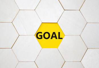 Goal symbol. Concept word Goal on wooden comb puzzle. Beautiful yellow background. Business and...